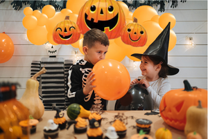 children having fun at a Halloween party with balloons