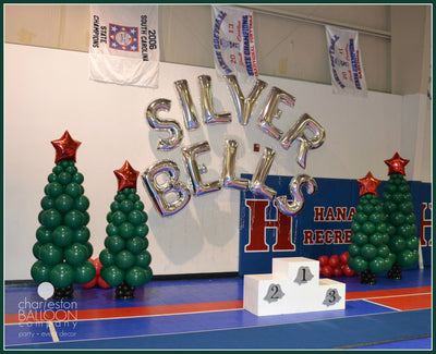 A Balloon Column that is in the shape of a classic green Christmas tree. Silver Bells Gymnastics Meet 2015