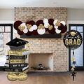 Graduation-themed decorations including balloons and a banner in front of a fireplace.