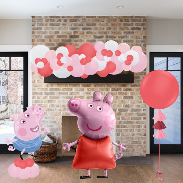 Decorative setup with Peppa Pig balloons and a brick wall background