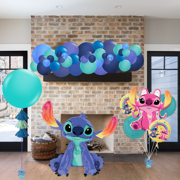 Decorative balloons and character figures in front of a brick fireplace.